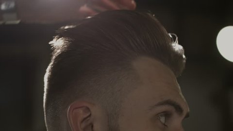 Men's hairstyling in a barbershop or hair salon. Barbershop.