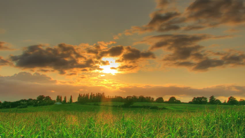 HDR time lapse of sunset over corn fields, high dynamic range imaging.