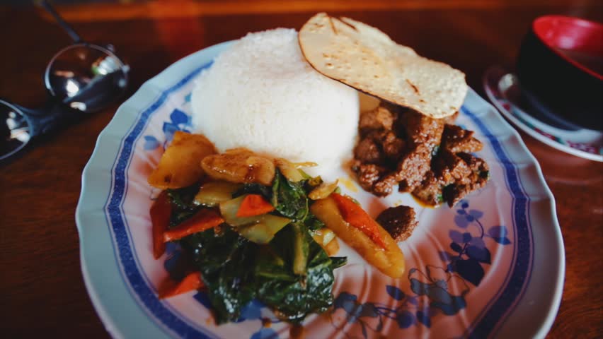 Dal Bhat, a traditional nepalese meal that consists of steamed rice and a cooked lentil soup called dal. And hot garlic soup. Pangboche village in the Himalaya, Nepal
