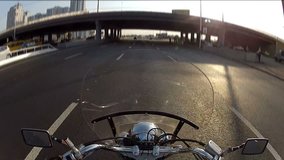 Biker driving the motorcycle on city highway, POV

