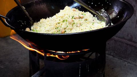 Fried rice cooking on big pan, HD slow motion