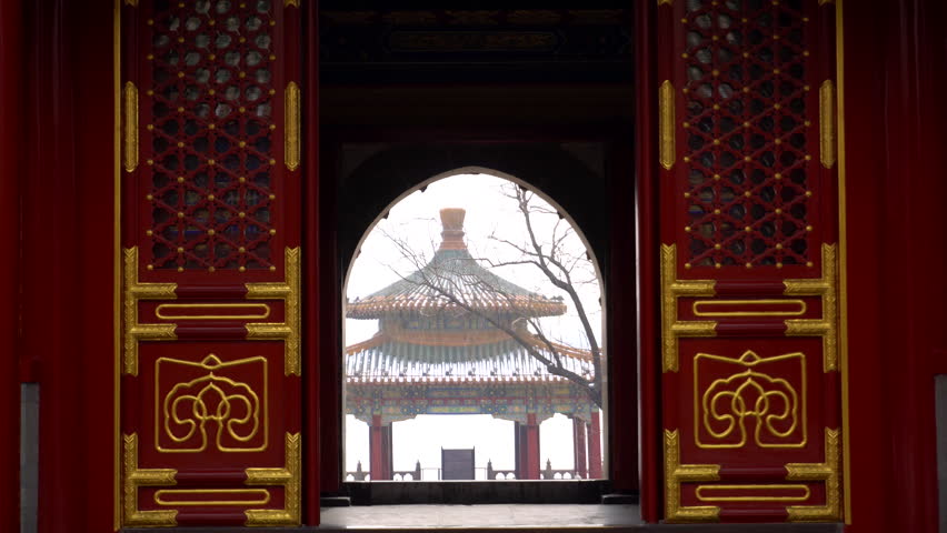 ancient pavilion seen from arch door of a temple in winter, Beijing Beihai park, China