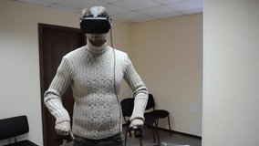 Man with glasses of virtual reality play a game in the office. Man using immersive technology and cybersecurity from virtual reality helmet or vr-headset with headset for fleeting self-expression