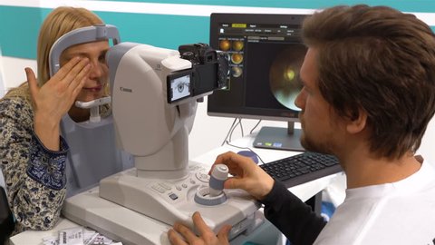 HELSINKI, FINLAND - JANUARY 17, 2017: Doctor examining woman's eyes with a modern digital measurement machine. Exhibition of medical equipment and services Doctor in 2017.