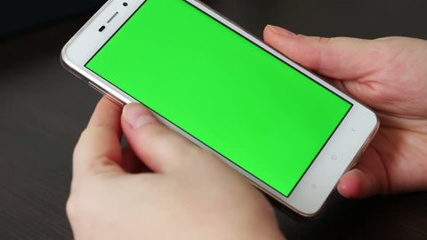 Touch Screen On White Smartphone Green Screen.Using Smartphone,Holding Smartphone with Green Screen
