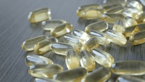 Healthy omega-3 fish oil soft gel capsules slow pan 