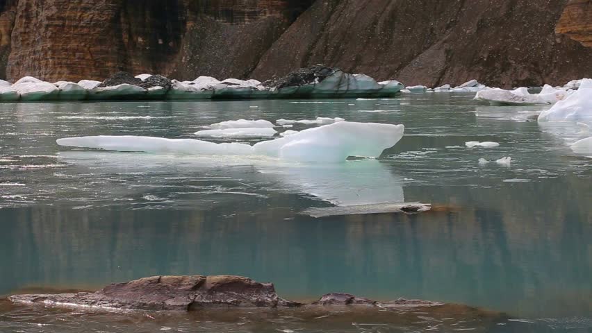 Glacial ice creaking and melting at Grinnell Glacier, Upper Grinnell Lake. Shot at Glacier National Park in Montana during the fall season. Audio of creaking ice included. Tripod stabilized.