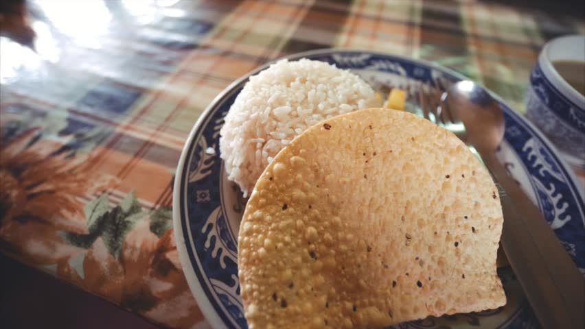 Dal Bhat, a traditional nepalese meal that consists of steamed rice and a cooked lentil soup called dal. And hot garlic soup. The Himalayas, Nepal