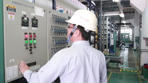 Penghu, Taiwan-03 November, 2014: An operator is controlling the reverse osmosis system in a water plant in Penghu, Taiwan. Reverse osmosis and nanofiltration are pressure-driven separation processes.