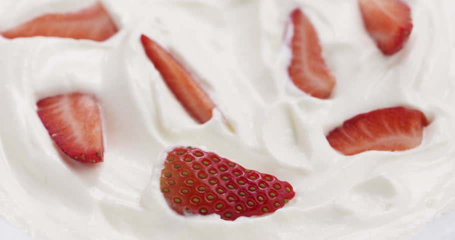 Slow motion of eating strawberries with cream with spoon, 4k 60fps 