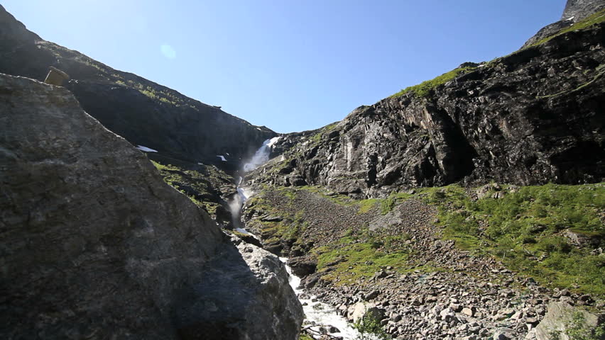Dollie shot of waterfall and river in Romsdal, Norway