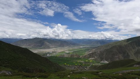 Stunning timelapse of Tibetan valley landscape of mountains and beautiful clouds