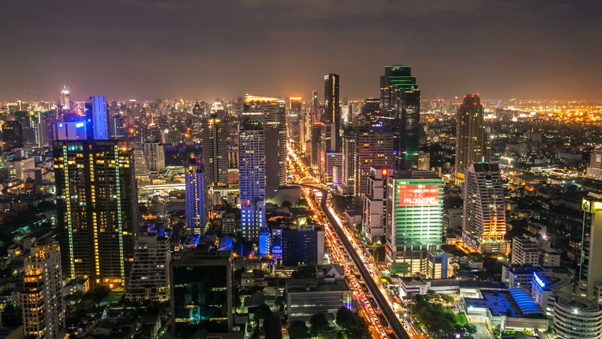BANGKOK - JUNE 24, 2012: Timelapse view on Sathorn street of skyline at night on