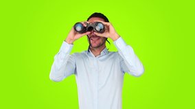 Surprised young man using a binoculars against green background - Powered by Shutterstock - Get 15% off with code: PIKWIZARD15