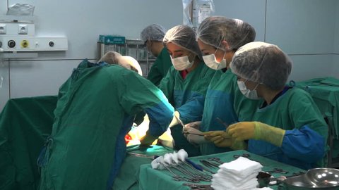 Baku, Azerbaijan-February 2016. Surgical team performing surgery operation, cesarean section. Gynecologists and midwifes giving birth. Maternity ward. Infant in maternity hospital