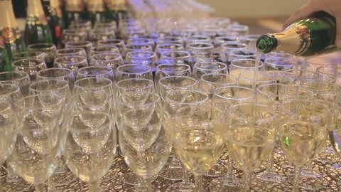 Buffet table, champagne is poured into glasses