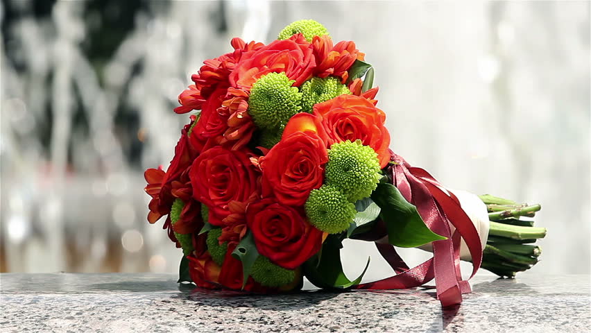 Bouquet of red and green flowers outside, Bride's bouquet  near the fountain