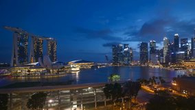 Sunrise night to day scene at Singapore Marina Bay city skyline. Zoom out