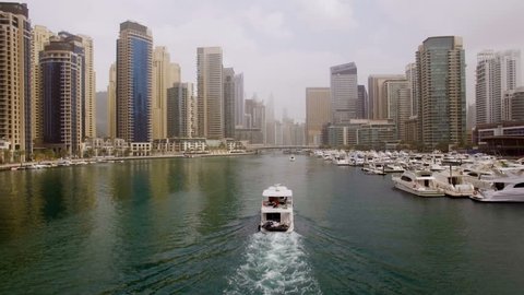 beautiful aerial view on bay with yachts and embankment among the skyscrapers in Dubai, UAE