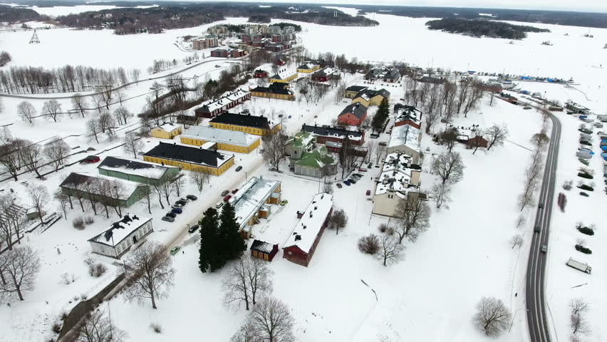 Color ancient wooden houses Fortress of Lappeenranta (Lappeenrannan linnoitus). Aerial view over frozen lake shore and harbour. Lappeenranta city, Finland