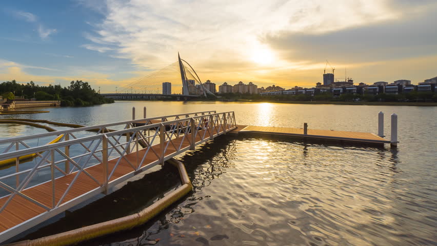 Timelapse of a boat jetty during beautiful sunset in Putrajaya, Malaysia overlooking the Purajaya bridge. Vibrant colour, Motion Time lapse Zoom Out