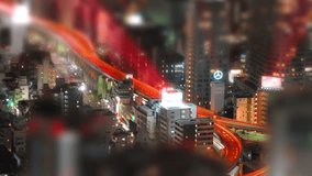 Tilt-shift (fake miniature) aerial time-lapse shot of Tokyo's busy city roads.