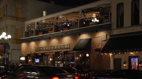 SAN DIEGO - Circa February, 2017 - A dusk establishing shot of a typical upscale bar and restaurant on 5th Avenue in San Diego's Gaslamp Quarter. 