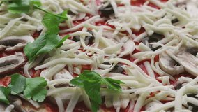Veggie pizza with mushrooms, olives, mozzarella cheese, leaves of fragrant greenery. The chef cooks a delicious pizza. Flat video style  for high-quality color grading.
