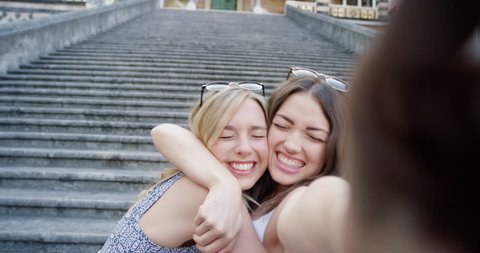 Best friends taking selfie with smartphone travelling together Tourist women sightseeing girls sharing summer vacation photo Piazza del Duomo, Amalfi, Italy
