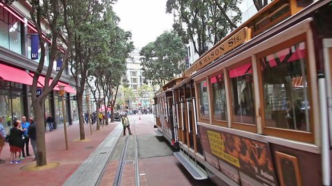 San Francisco, California, United States - August 17, 2016: Cable Car, Powell-Manson lines, of San Francisco, starting its ride from Powell station, along Powell Street, passing by Burger King.