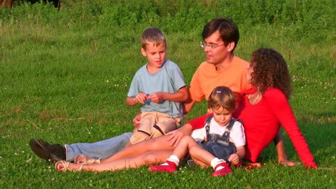 family of four on grass 