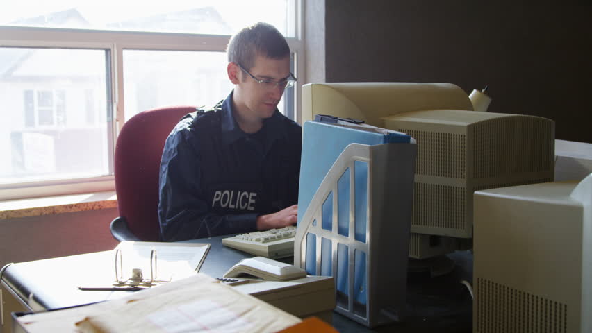 police-officer-desk-precinct-entering-data-stock-footage-video-100