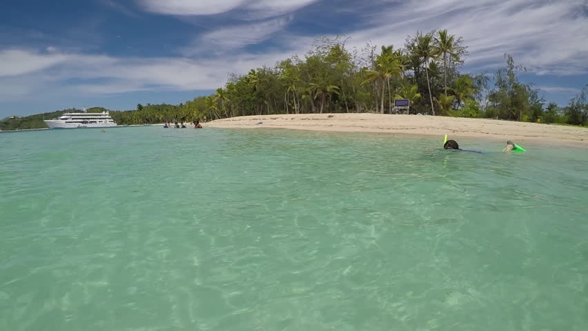 Young woman snorkeling in The Blue Lagoon on Nanuya Lailai Island Fiji South Pacific