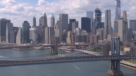 AERIAL: Beautiful view of iconic downtown New York skyscrapers, office buildings and Brooklyn and Manhattan Bridges across East River. Amazing New York City skyline cityscape on a gorgeous sunny day