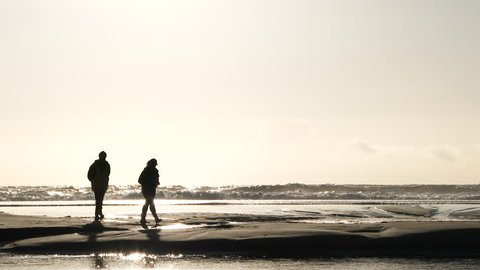 Unrecognizable Silhouetted Couple Walk Through Frame Stock Footage ...