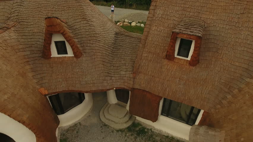 Bride and groom romantic scene next to a house at countryside