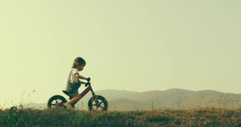 Little girl learns to keep balance while riding a bicycle, New family and baby healthy concept