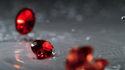 Ruby spinning on water surface. Shot with high speed camera, phantom flex 4K. Slow Motion.