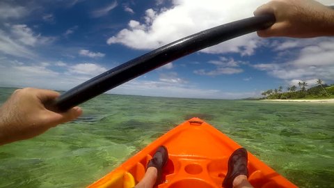 Point of view of a man in a kayak, kayaking along coastline of a tropical resort in the Coral Coast in Viti Levu Island, Fiji. 