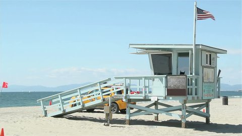 Lifeguard tower near Venice beach, United States flag is rasied, beach is empty