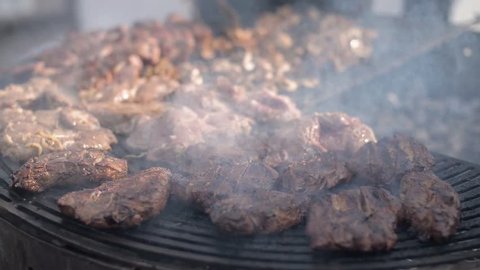 People cook barbecue grill, grilled steak, Frying fresh meat, Chicken BBQ, sausage, kebabs, hamburger, picnic with mushrooms and meat