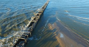 Aerial shot of abandoned pier collapsed into the Baltic sea coast, Lithuania - 012