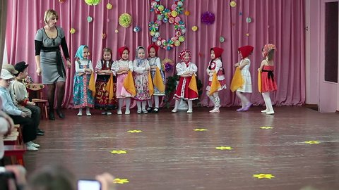ST. PETERSBURG, RUSSIA - CIRCA MAR, 2013: Pretty girls in Russian traditional clothes dance on the stage. Show for parents is dedicated the International Women's Day (March, 8)