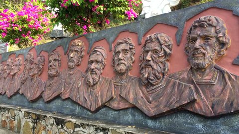 VUNG TAU, VIETNAM - FEB. 9, 2017: The stone plate depicting Twelve Apostles of Jesus Christ, located on a slope to the giant statue of Christ. It is one of the most popular local place of interest.
