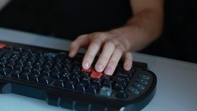Man play video game using keyboard with red buttons