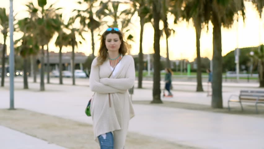 Bautiful woman walking in exotic place and smiling to the camera, steadycam shot
