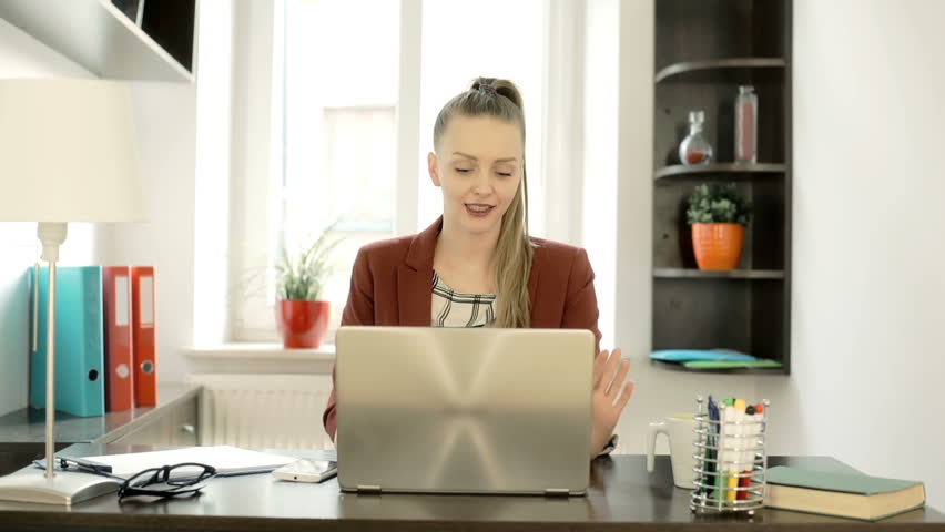 Businesswoman sitting in the office and having a videochat on laptop, steadycam shot
 | Shutterstock HD Video #24400499