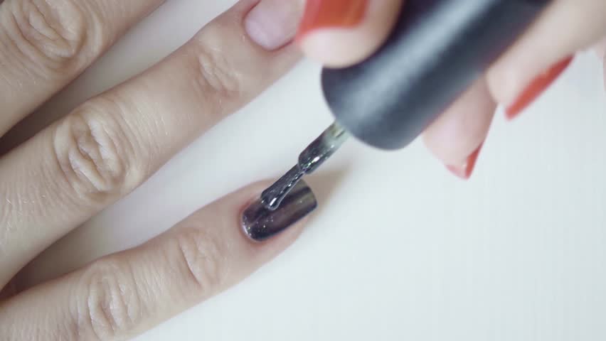 Application of colored nail of lacquer on the right hand into a single layer | Shutterstock HD Video #24402263