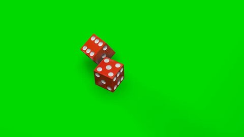Two rolling red dices falling on green table.