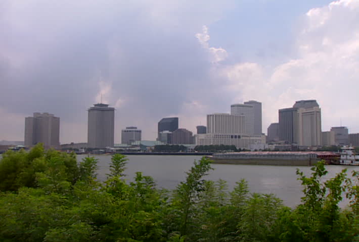 NEW ORLEANS - Circa 2002: New Orleans business district and a barge on the Mississippi River in 2002.